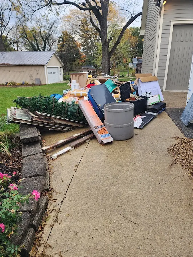Dumpster being loaded with debris for Commercial Dumpster Rental in Conroe